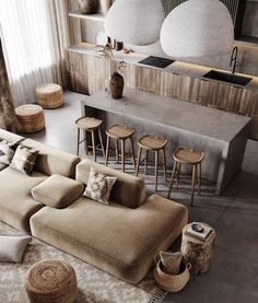 a living room filled with lots of furniture next to a counter top and bar area