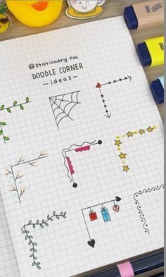 a notebook with doodle corner designs on it next to crayons and markers