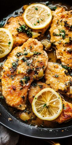 chicken with lemons and herbs cooking in a skillet