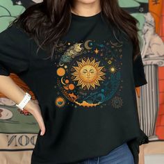 Celestial Sun & Stars T-Shirt, Boho Celestial Shirt, Gift for Her, Celestial Sun Shirt, Vintage Sun T, Astrology T Shirt, Celestial Stars Get ready to elevate your boho fashion game with this stunning Celestial Sun & Stars T-Shirt. Perfect for the astrology lover in your life, this t-shirt is a must-have addition to any wardrobe. This top is handmade with care and precision, ensuring that every detail is perfect.  - Unique design with a celestial theme  - Handmade with high-quality materials  - Celestial Graphic Tee, Celestial Short Sleeve Tops With Moon Print, Celestial Crew Neck Tops For Summer, Celestial Boho, Celestial Style Graphic T-shirt For Summer, Celestial Graphic Print T-shirt For Summer, Celestial Graphic Print Summer Tops, Celestial Graphic Print Tops For Summer, Summer Celestial Graphic Print Tops