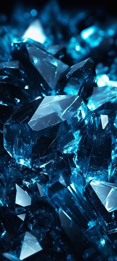 many blue crystals are scattered together on the floor in this photo, with one glowing