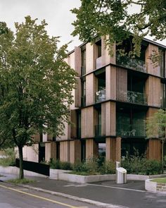 an apartment building with wooden balconies on the front and side of it's sides