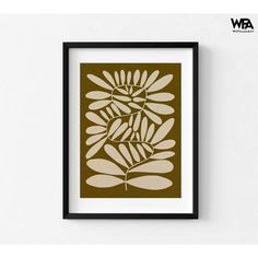 a brown and white art print with leaves on it's back wall mounted in a black frame