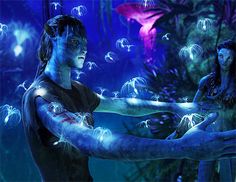 two people with painted arms and body in front of an aquarium filled with jelly fish