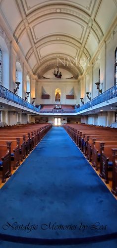 an empty church with blue carpet and pews