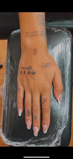 a woman's hand with tattoos on it