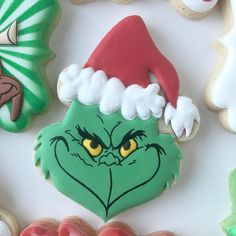 the grin face cookie is surrounded by decorated cookies