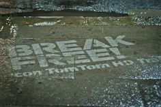 a street sign that reads break free on the sidewalk