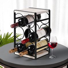 a wine rack with several bottles and two glasses