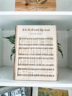 the shelves are filled with music sheets and other items for sale on it's own shelf