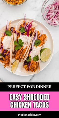 three shredded chicken tacos on a white plate with red onions and cilantro