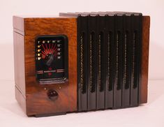 an old fashioned radio sitting on top of a white table next to some black books