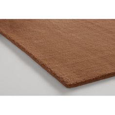 a brown rug on top of a white floor