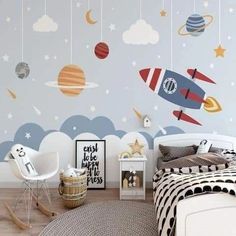 a child's bedroom decorated with space themed wall decals and decorating the walls