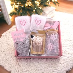 a pink box filled with gifts on top of a white rug