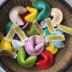 a basket filled with lots of colorful ceramic birds