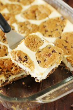 a close up of a cake with white frosting and chocolate chip cookies on top