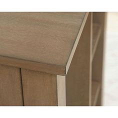 a close up view of the top of a wooden cabinet with drawers and doors on both sides