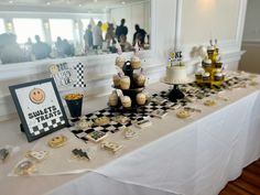 a table topped with lots of cupcakes and cakes