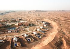 an aerial view of a desert village in the middle of nowhere