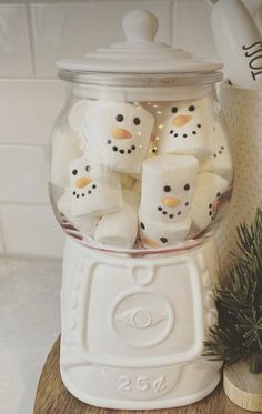 some marshmallows in a glass jar on a table