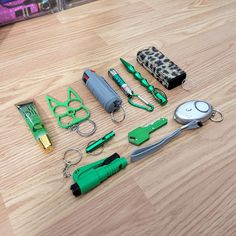 the contents of an emergency kit laid out on a wooden floor with scissors and other items