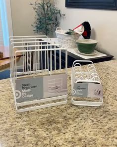 there are two plastic containers sitting on the counter next to each other, one has a bird in it's cage