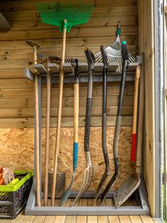 an organized storage shed with shovels and gardening tools