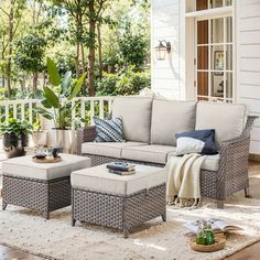 an outdoor living room with furniture and plants on the patio area, including couches and ottomans