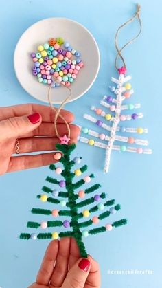 someone is making a christmas tree ornament out of beads