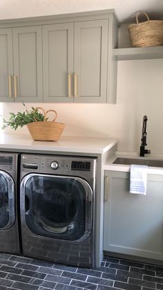 a washer and dryer sitting in a kitchen next to each other on top of a counter