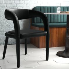 two black chairs sitting next to each other near a table