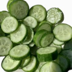 sliced cucumbers are arranged on a white surface