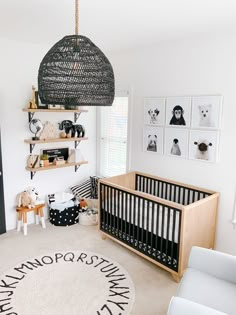 a baby's room is decorated with black and white decor, including a crib