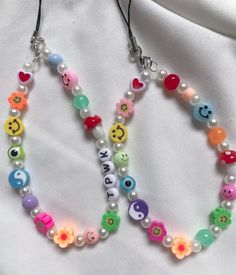 two necklaces with colorful beads and letters on them