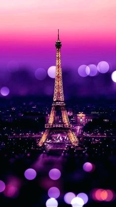 the eiffel tower is lit up in purple and pink colors at night time