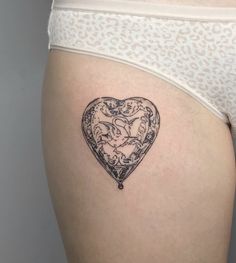 a woman's stomach with a tattoo on it that is shaped like a heart