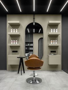 a salon chair in front of a mirror and shelves