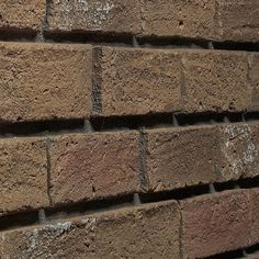 a close up of a brick wall with no mortar