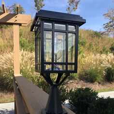 an old fashioned street light sitting on top of a wooden bench