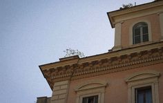 an old building with two windows and a clock on the top