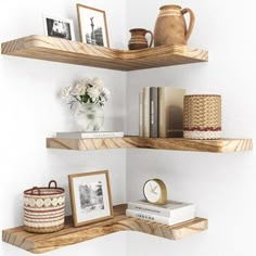 two wooden shelves with pictures and other items on them