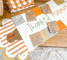 a turkey themed thanksgiving table runner on a kitchen counter with the words thank you written on it