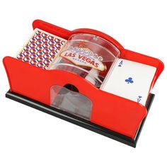 a red tray with cards, dices and playing cards in it on a white background