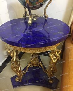 a blue and gold table sitting on top of a chair