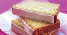 two slices of cake sitting on top of each other in front of a pink background