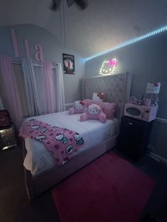 a bedroom with hello kitty bedding and pink rugs