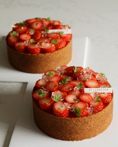 two small cakes with strawberries on top