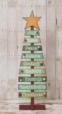 a christmas tree made out of wooden planks with the words joy, love, peace and good will