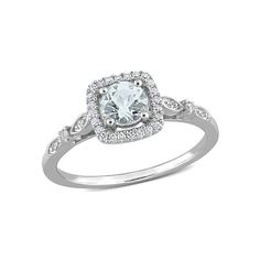 an engagement ring with a cushion cut aqua blue topazte surrounded by white diamonds